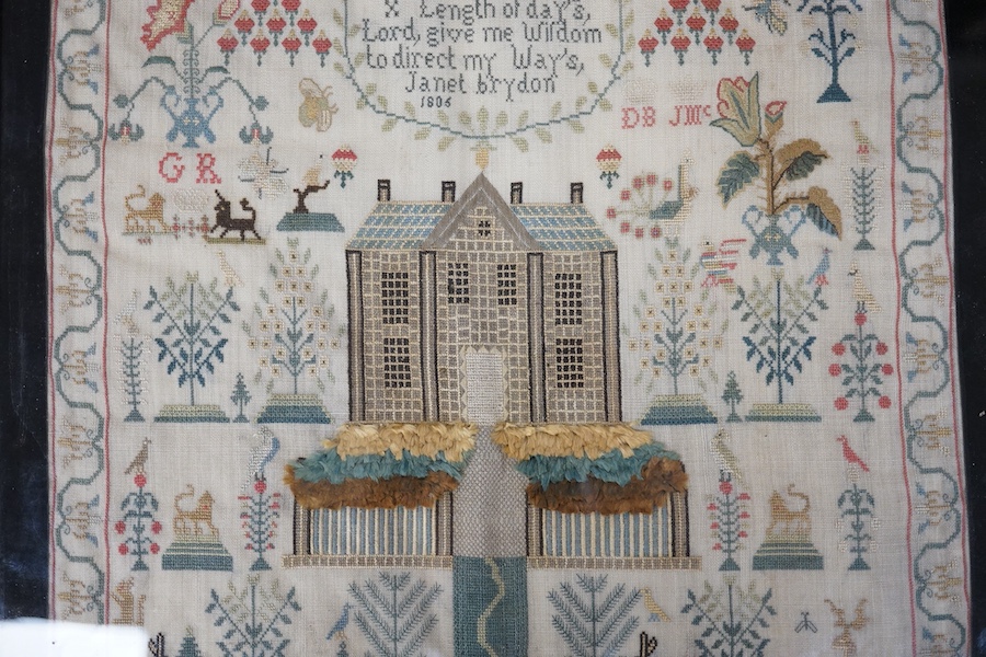 A George lll needlework sampler dated 1806, by Janet Brydon. Worked on fine linen, the sampler embroidered with ornate motifs of angels, birds, deer, lions and a castle around a short embroidered script; I ask not riches